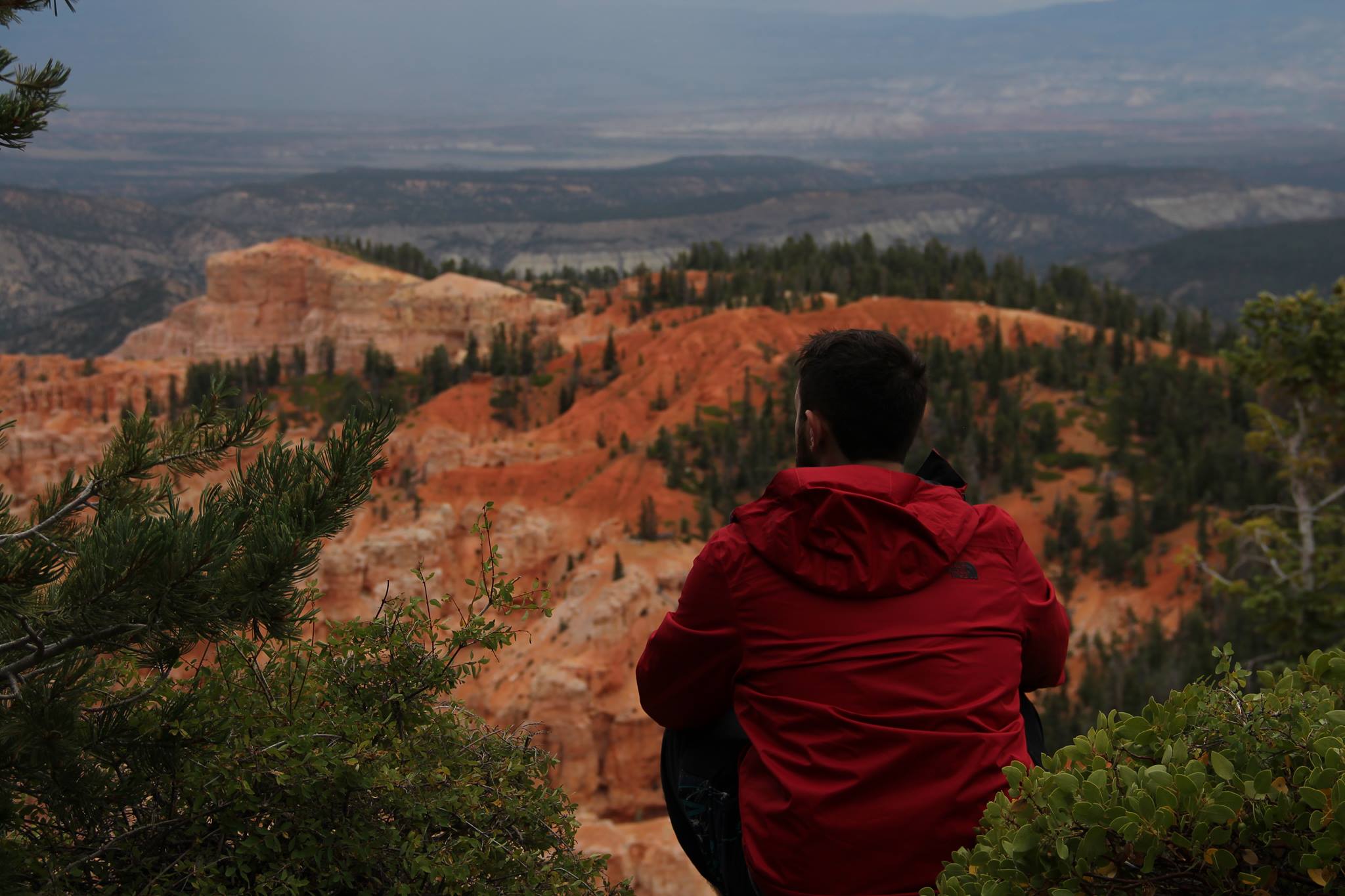 James Wolf sitting at a canyon overlook in Utah